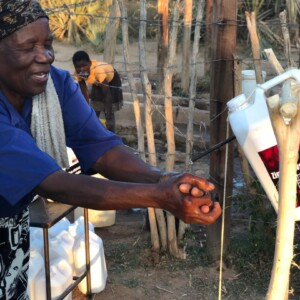 Vita Mloyi, a member of the Rural Womens Assembly in Dakamela, demontrates the proper washing of hands